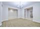 Bright and airy living room with neutral tones, tile flooring, and contemporary lighting at 2830 E Fruitvale Ave, Gilbert, AZ 85297