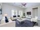 Modern living room featuring white sofas with blue pillows, a decorative coffee table, and neutral-toned accents at 2830 E Fruitvale Ave, Gilbert, AZ 85297