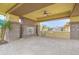 Outdoor kitchen featuring a stone fireplace, ceiling fan, granite counters, a built-in BBQ, and paver flooring at 2830 E Fruitvale Ave, Gilbert, AZ 85297