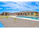 In-ground pool with bright blue water, stone patio, and views of the back of the home at 2830 E Fruitvale Ave, Gilbert, AZ 85297