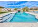 In-ground pool with bright blue water and steps, plus a rock water slide in the background at 2830 E Fruitvale Ave, Gilbert, AZ 85297