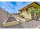 Landscape detail along home's exterior with rock covering and small raised garden boxes at 2830 E Fruitvale Ave, Gilbert, AZ 85297