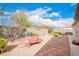 Rockscape backyard with desert plants and a brick paver walkway at 3301 S Goldfield Rd # 2105, Apache Junction, AZ 85119