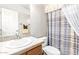 Cozy bathroom featuring a single sink vanity, framed mirror, and a shower with blue plaid shower curtain at 3301 S Goldfield Rd # 2105, Apache Junction, AZ 85119