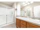 Bright bathroom with dual sinks, a glass-enclosed shower, and vanity at 3301 S Goldfield Rd # 2105, Apache Junction, AZ 85119