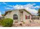 Charming single-story home featuring a well-manicured front yard, covered carport, and red shutters at 3301 S Goldfield Rd # 2105, Apache Junction, AZ 85119