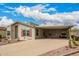 Single-story home featuring a covered carport, low-maintenance landscaping, and red shutters at 3301 S Goldfield Rd # 2105, Apache Junction, AZ 85119