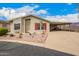 Charming single-story home features a covered carport and well-manicured desert landscaping in the front yard at 3301 S Goldfield Rd # 2105, Apache Junction, AZ 85119