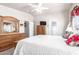 Bright main bedroom with a ceiling fan, white walls, and wood furniture at 3301 S Goldfield Rd # 2105, Apache Junction, AZ 85119