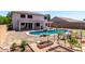 Beautiful backyard featuring a swimming pool, patio, garden boxes, and an irrigation system at 34990 N Spur Cir, San Tan Valley, AZ 85144