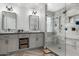 This bathroom features a double vanity, tile floor, and glass enclosed shower with tile surround at 34990 N Spur Cir, San Tan Valley, AZ 85144