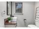 Half-bathroom featuring a modern square sink, wooden countertop, toilet, and framed mirror and a window at 34990 N Spur Cir, San Tan Valley, AZ 85144