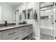 Elegant bathroom featuring double sinks, a shower with tile, and modern fixtures for a luxurious feel at 34990 N Spur Cir, San Tan Valley, AZ 85144