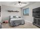 This bedroom has a large window, ceiling fan and television and a minimalist design at 34990 N Spur Cir, San Tan Valley, AZ 85144