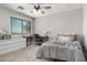 This bedroom boasts a large window, ceiling fan, desk area and drawers at 34990 N Spur Cir, San Tan Valley, AZ 85144