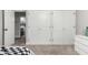 This bedroom has a view to an adjacent room, three closet doors, and a dresser at 34990 N Spur Cir, San Tan Valley, AZ 85144