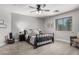 Bedroom featuring a comfortable bed, matching end tables, ceiling fan, and decorative wall decor at 34990 N Spur Cir, San Tan Valley, AZ 85144