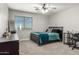 This bedroom includes ceiling fan, corner desk and natural light at 34990 N Spur Cir, San Tan Valley, AZ 85144