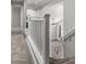 Second floor hallway with neutral carpeting and railings, offering a glimpse of the living room below at 34990 N Spur Cir, San Tan Valley, AZ 85144