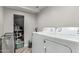 Efficient laundry room with modern appliances, storage space, and stylish flooring for convenience at 34990 N Spur Cir, San Tan Valley, AZ 85144