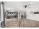Open living space featuring stylish flooring, a ceiling fan, and an eat-in kitchen area at 34990 N Spur Cir, San Tan Valley, AZ 85144