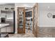 Walk-in pantry with decorative wood doors, ample shelving, and stylish brick flooring, ideal for organization at 34990 N Spur Cir, San Tan Valley, AZ 85144