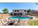 Enjoy a private backyard oasis with a large swimming pool and cozy seating area at 34990 N Spur Cir, San Tan Valley, AZ 85144