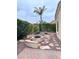 Backyard featuring a circular fire pit with benches, desert landscaping, and a palm tree at 4203 E Narrowleaf Dr, Gilbert, AZ 85298