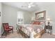 Cozy bedroom featuring shuttered window, artwork, a wrought iron bed frame, and decorative bedside lighting at 4203 E Narrowleaf Dr, Gilbert, AZ 85298