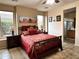 Bedroom featuring a queen bed, Southwestern artwork, and ensuite bathroom access at 4203 E Narrowleaf Dr, Gilbert, AZ 85298