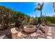 Cozy backyard fire pit with built-in seating, set in a private and landscaped outdoor space at 4203 E Narrowleaf Dr, Gilbert, AZ 85298