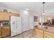 Bright kitchen with a large refrigerator, plenty of cabinet space, and a view of the adjacent dining and living areas at 4203 E Narrowleaf Dr, Gilbert, AZ 85298