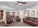 Open-concept living room with leather furnishings, tile flooring, and access to the kitchen area at 4203 E Narrowleaf Dr, Gilbert, AZ 85298