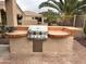 Well-equipped outdoor grill station with tile countertops, ideal for backyard barbecues and entertaining guests at 4203 E Narrowleaf Dr, Gilbert, AZ 85298