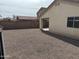 Fully fenced backyard with gravel and a peek-a-boo view of the neighbor's house at 43818 W Arizona Ave, Maricopa, AZ 85138