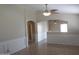 Spacious living area featuring tile floors and a ceiling fan at 43818 W Arizona Ave, Maricopa, AZ 85138