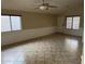 Inviting living room with tile flooring, decorative trim, and bright windows at 43818 W Arizona Ave, Maricopa, AZ 85138