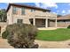 Spacious backyard featuring a covered patio, lush lawn, and low-maintenance desert landscaping at 45717 W Ranch Rd, Maricopa, AZ 85139