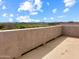 Expansive balcony view overlooking the fields and mountains with a blue sky backdrop, adding natural beauty at 45717 W Ranch Rd, Maricopa, AZ 85139