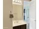 Bright bathroom featuring a single sink vanity, a large mirror, and neutral color palette at 45717 W Ranch Rd, Maricopa, AZ 85139