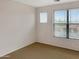 Bedroom featuring windows with blinds and neutral-colored walls at 45717 W Ranch Rd, Maricopa, AZ 85139