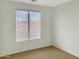 Bright bedroom featuring a large window and neutral-colored walls at 45717 W Ranch Rd, Maricopa, AZ 85139