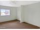 Bedroom with a window providing natural light and neutral carpeted flooring at 45717 W Ranch Rd, Maricopa, AZ 85139