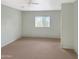 Bright bedroom with a window and neutral carpet, creating a welcoming space at 45717 W Ranch Rd, Maricopa, AZ 85139