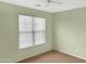 Neutral bedroom featuring ceiling fan, a window and neutral-colored walls at 45717 W Ranch Rd, Maricopa, AZ 85139