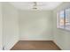 Bedroom with neutral walls and carpet flooring, illuminated by a large window at 45717 W Ranch Rd, Maricopa, AZ 85139