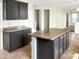 Kitchen with granite countertops and a center island with dark cabinets at 45717 W Ranch Rd, Maricopa, AZ 85139