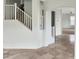 Neutral staircase with white railings, leading to upstairs, visible from tiled floor at 45717 W Ranch Rd, Maricopa, AZ 85139