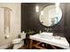 Powder room featuring unique design elements like dark subway tile, modern vanity and lighting, plus a decorative mirror at 6455 E Calle Del Media --, Scottsdale, AZ 85251