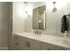 Bright bathroom featuring marble counters, sleek vanity, modern fixtures, and a mirror with decorative sconces at 6455 E Calle Del Media --, Scottsdale, AZ 85251